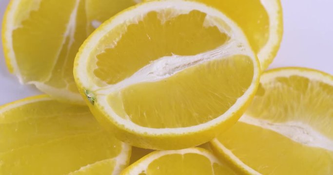 Fresh sliced orange rotating on white surface. Close up of vitamin detox fruit.  4k food isolated.