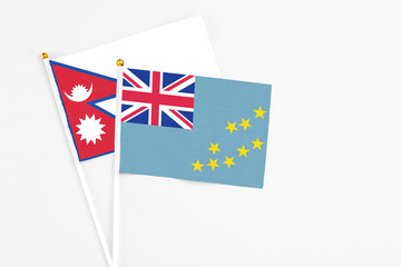 Tuvalu and Nepal stick flags on white background. High quality fabric, miniature national flag....