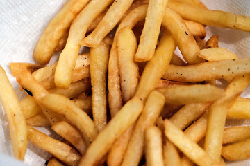 Delicious looking french fries on white paper napkin