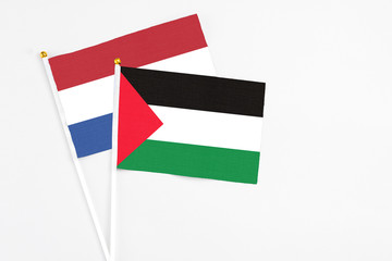 Palestine and Netherlands stick flags on white background. High quality fabric, miniature national...