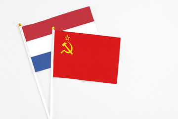 Soviet Union and Netherlands stick flags on white background. High quality fabric, miniature national flag. Peaceful global concept.White floor for copy space.