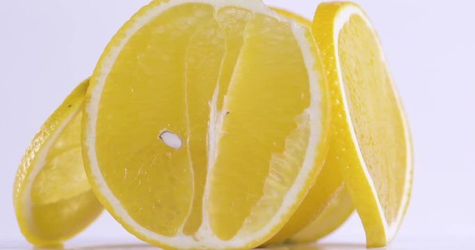 Fresh sliced orange rotating on white surface. Close up of vitamin detox fruit.  4k food isolated.