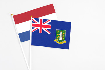 British Virgin Islands and Netherlands stick flags on white background. High quality fabric, miniature national flag. Peaceful global concept.White floor for copy space.