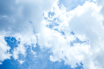 bottom view of blue sky with white clouds and sunshine