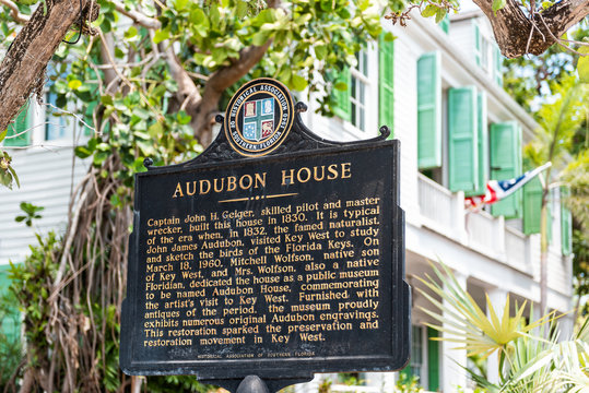 Key West, USA - May 1, 2018: Audubon house historic landmark on street architecture with tourist information sign closeup in Florida city travel, sunny day