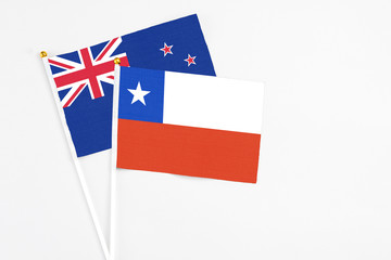 Chile and New Zealand stick flags on white background. High quality fabric, miniature national flag. Peaceful global concept.White floor for copy space.