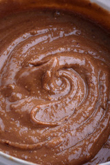 peanut butter and peanuts on grey background , top view