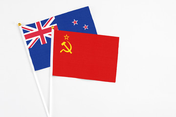 Soviet Union and New Zealand stick flags on white background. High quality fabric, miniature national flag. Peaceful global concept.White floor for copy space.