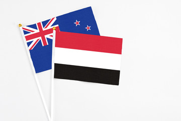 Yemen and New Zealand stick flags on white background. High quality fabric, miniature national flag. Peaceful global concept.White floor for copy space.