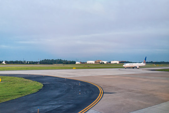 Dulles, USA - June 13, 2018: Dulles Internation Airport, IAD, with Icelandair airplane during sunset evening with view of terminal in Virginia, large plane, airfield runway