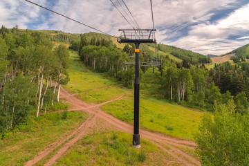 Intersecting hiking trails and metal chairlifts viewed in Park City in summer
