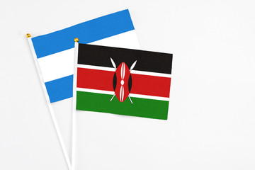 Kenya and Nicaragua stick flags on white background. High quality fabric, miniature national flag. Peaceful global concept.White floor for copy space.