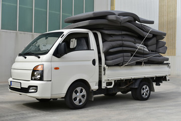 small flatbed truck full of mattresses