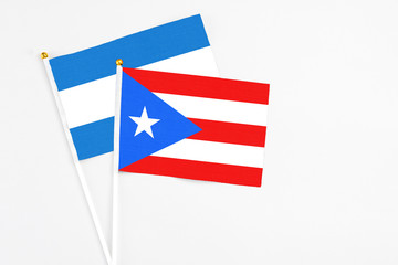 Puerto Rico and Nicaragua stick flags on white background. High quality fabric, miniature national flag. Peaceful global concept.White floor for copy space.