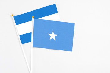 Somalia and Nicaragua stick flags on white background. High quality fabric, miniature national flag. Peaceful global concept.White floor for copy space.