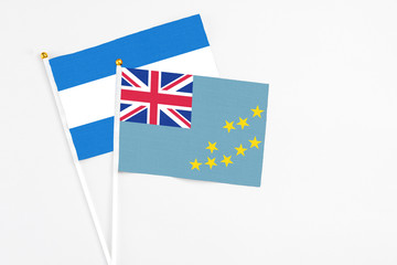 Fototapeta premium Tuvalu and Nicaragua stick flags on white background. High quality fabric, miniature national flag. Peaceful global concept.White floor for copy space.