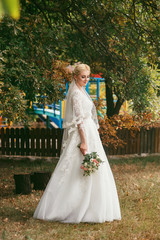 Obraz na płótnie Canvas Beautiful bride with bouquet of flowers outdoor