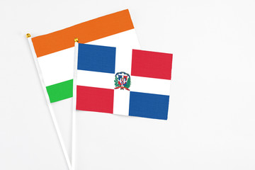 Dominican Republic and Niger stick flags on white background. High quality fabric, miniature...