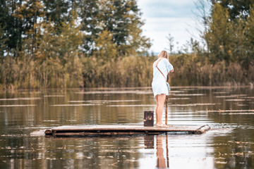 girl in white on a raft