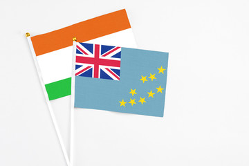 Tuvalu and Niger stick flags on white background. High quality fabric, miniature national flag....