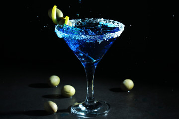 A glass with blue martini cocktail	