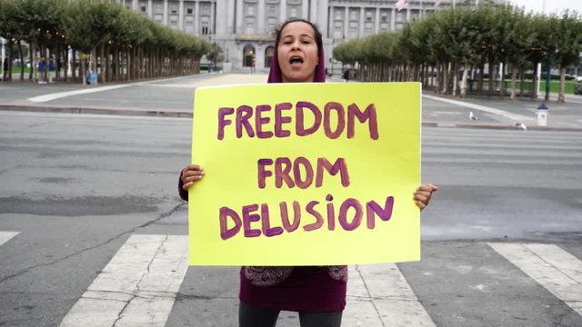 Freedom from delusion sign- woman speaks out in slow motion