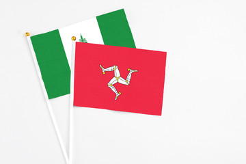 Isle Of Man and Norfolk Island stick flags on white background. High quality fabric, miniature...