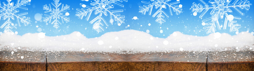 Christmas winter snow background panorama banner long - Snowy wooden rustic table with snowflakes...