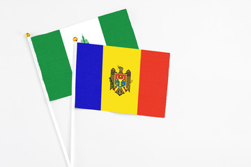 Moldova and Norfolk Island stick flags on white background. High quality fabric, miniature national flag. Peaceful global concept.White floor for copy space.