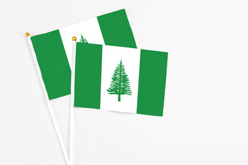 Norfolk Island and Norfolk Island stick flags on white background. High quality fabric, miniature national flag. Peaceful global concept.White floor for copy space.