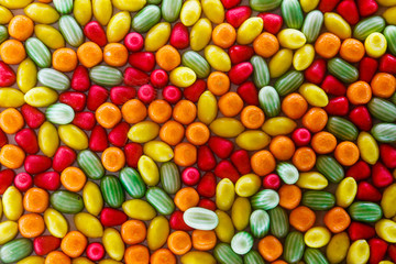 Bright, juicy, sweet, colored background of candies and sweets in the form of fruits and berries - orange, watermelon, raspberries, lemon.