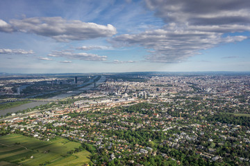 Aerial drone shot of vienna city with dramatic clouds in sunny day