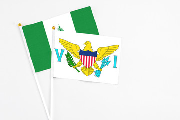 United States Virgin Islands and Norfolk Island stick flags on white background. High quality fabric, miniature national flag. Peaceful global concept.White floor for copy space.
