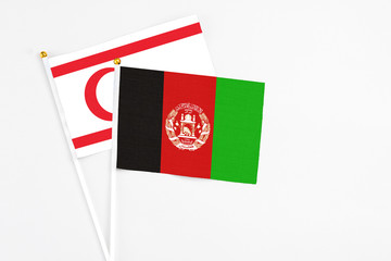 Afghanistan and Northern Cyprus stick flags on white background. High quality fabric, miniature...