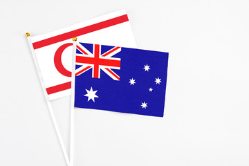 Fototapeta premium Australia and Northern Cyprus stick flags on white background. High quality fabric, miniature national flag. Peaceful global concept.White floor for copy space.