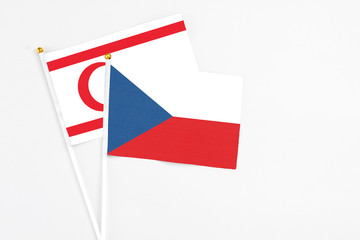 Czech Republic and Northern Cyprus stick flags on white background. High quality fabric, miniature national flag. Peaceful global concept.White floor for copy space.