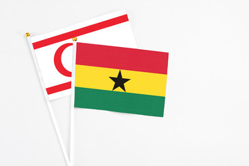 Ghana and Northern Cyprus stick flags on white background. High quality fabric, miniature national flag. Peaceful global concept.White floor for copy space.