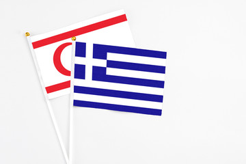 Greece and Northern Cyprus stick flags on white background. High quality fabric, miniature national flag. Peaceful global concept.White floor for copy space.