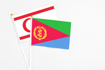 Eritrea and Northern Cyprus stick flags on white background. High quality fabric, miniature national flag. Peaceful global concept.White floor for copy space.