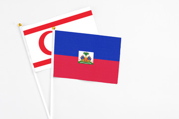Haiti and Northern Cyprus stick flags on white background. High quality fabric, miniature national...