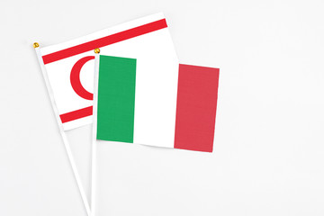 Italy and Northern Cyprus stick flags on white background. High quality fabric, miniature national flag. Peaceful global concept.White floor for copy space.