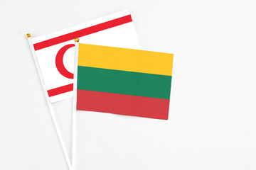 Lithuania and Northern Cyprus stick flags on white background. High quality fabric, miniature national flag. Peaceful global concept.White floor for copy space.