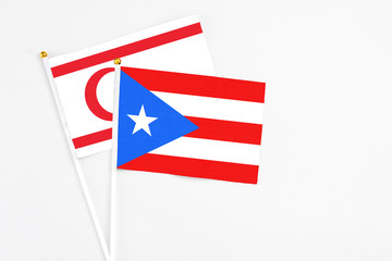 Puerto Rico and Northern Cyprus stick flags on white background. High quality fabric, miniature national flag. Peaceful global concept.White floor for copy space.