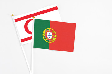 Portugal and Northern Cyprus stick flags on white background. High quality fabric, miniature national flag. Peaceful global concept.White floor for copy space.