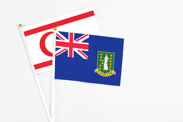 British Virgin Islands and Northern Cyprus stick flags on white background. High quality fabric, miniature national flag. Peaceful global concept.White floor for copy space.