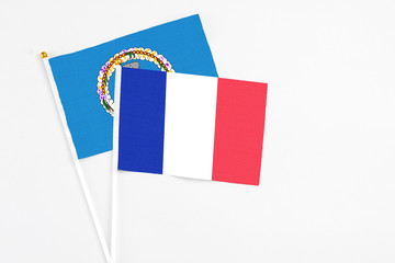 France and Northern Mariana Islands stick flags on white background. High quality fabric, miniature national flag. Peaceful global concept.White floor for copy space.