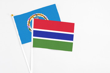 Gambia and Northern Mariana Islands stick flags on white background. High quality fabric, miniature national flag. Peaceful global concept.White floor for copy space.