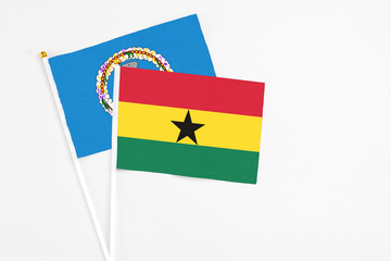 Ghana and Northern Mariana Islands stick flags on white background. High quality fabric, miniature national flag. Peaceful global concept.White floor for copy space.