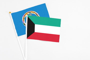 Kuwait and Northern Mariana Islands stick flags on white background. High quality fabric, miniature national flag. Peaceful global concept.White floor for copy space.