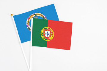 Portugal and Northern Mariana Islands stick flags on white background. High quality fabric, miniature national flag. Peaceful global concept.White floor for copy space.